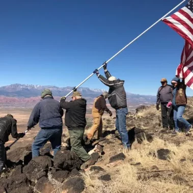 Tri state atv club raising american flag.