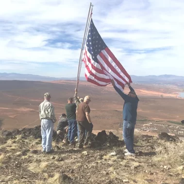 Tri state atv club raising flag on flag mountain.